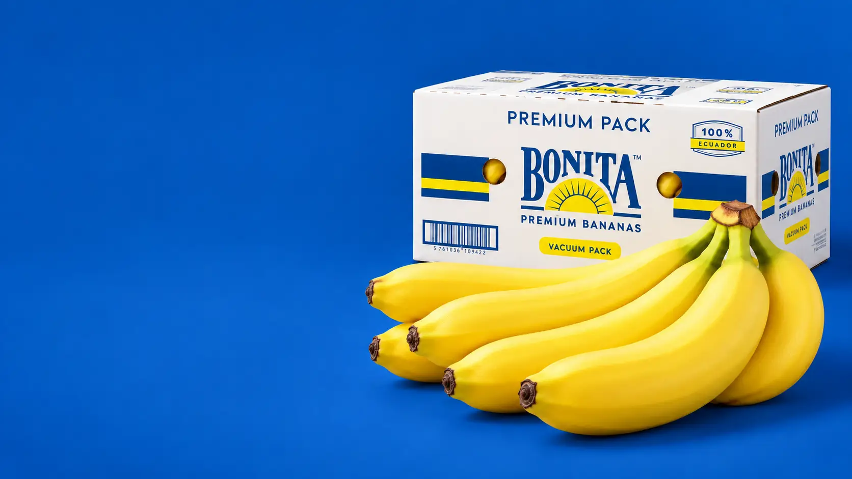 Caja Premium Pack de Bonita junto a un racimo de banano sobre fondo azul.